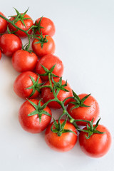 Healthy food ingredient - raw tomatoes on white background, vibrant colours, vitamin food, space for text