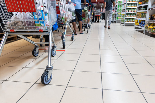 People Embracing The New Normal With Social Distancing In Checking Out At Supermarket