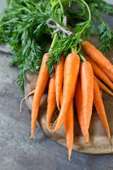 Bunch of fresh farmers market carrots on wooden background 