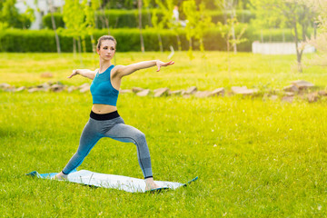Obraz na płótnie Canvas Young Caucasian woman doing yoga in the Park.