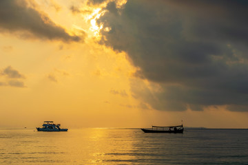 A boat in the sea with the sunset background at Koh Ta Kiev, Cambodia