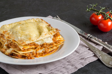Meat lasagna on a wooden background.