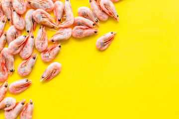 Shrimps background on yellow table top view frame copy space