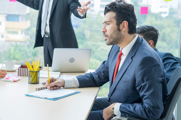 Business men and executives sit meeting to schedule policies in the meeting room .


