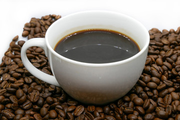white coffee cup and roasted coffee beans that isolated on white background. top view.