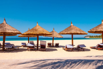 Luxury resort. Umbrellas and chairs on the beach near ocean