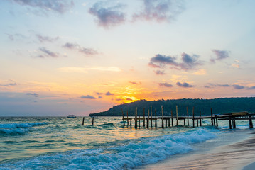 Obraz premium Sok San Beach, Koh Rong, Cambodia- Feb, 2020 : a wooden pier and a beautiful sunset from the Sok San Beach, Koh Rong, Cambodia