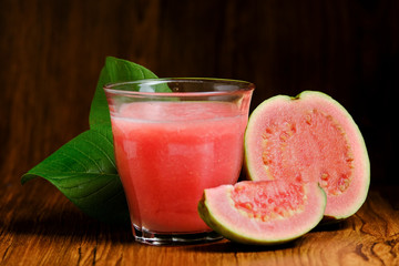 guava juice is served on a wooden background