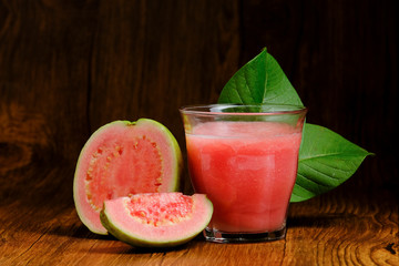 guava juice is served on a wooden background