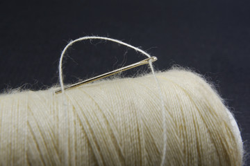 A thread through needle hole on a thread roll