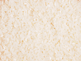 Raw white round grain rice as background. Healthy eating concept