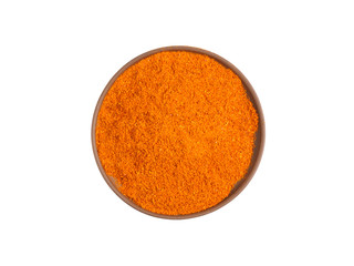 Red chili pepper powder on brown clay plate isolated on white