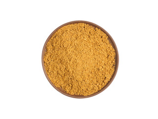Masala powder on brown clay plate isolated on white. Healthy eating, ayurveda, naturopathy concept