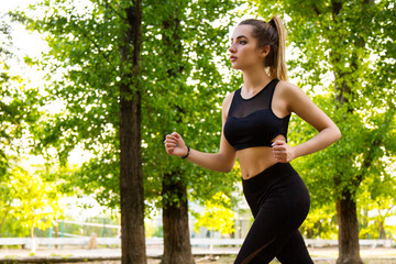 A young woman Jogging in the Park. The view from the side