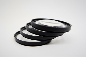 A pile of close up lens 58 mm stacked sideways, for camera accessories
