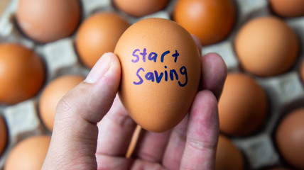 Start saving concept. An egg with text start saving