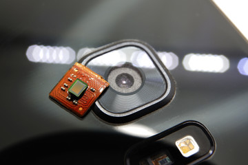 Smartphone image sensor detached with white background placed on smartphone camera