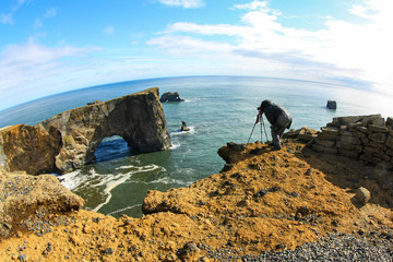 The photographer is standing on the cliff make for an incredible picture. The breach of security.