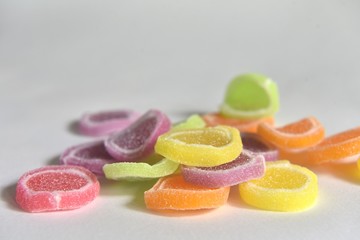 Jelly candy with many different colors on a white background

￼