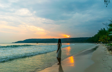 Long Set Beach, Koh Rong, Cambodia- Feb, 2020 : a lady enjoying a beautiful sunset from Long Set Beach, Koh Rong, Cambodia