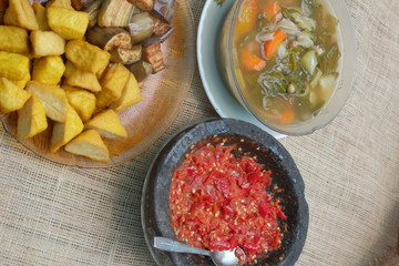 Indonesian traditional food, chilli paste, sour soup, fried eggplant and tofu.