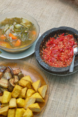 Indonesian traditional food, chilli paste, sour soup, fried eggplant and tofu.