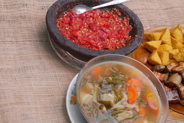 Indonesian traditional food, chilli paste, sour soup, fried eggplant and tofu.