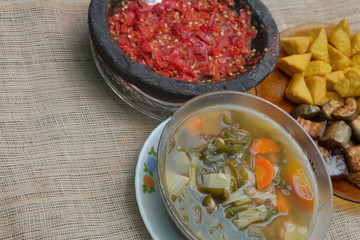 Indonesian traditional food, chilli paste, sour soup, fried eggplant and tofu.