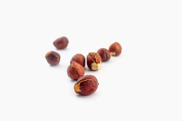 A few hazelnuts isolated on a white background. Well suited for baking or in healthy muesli.