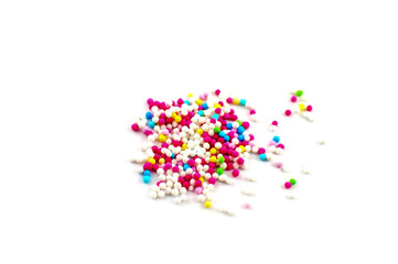 A bunch of colorful sugar pearls isolated on white background.