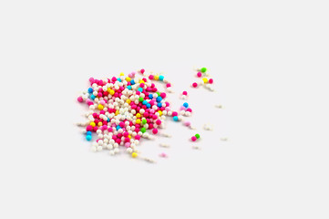 A bunch of colorful sugar pearls isolated on white background.