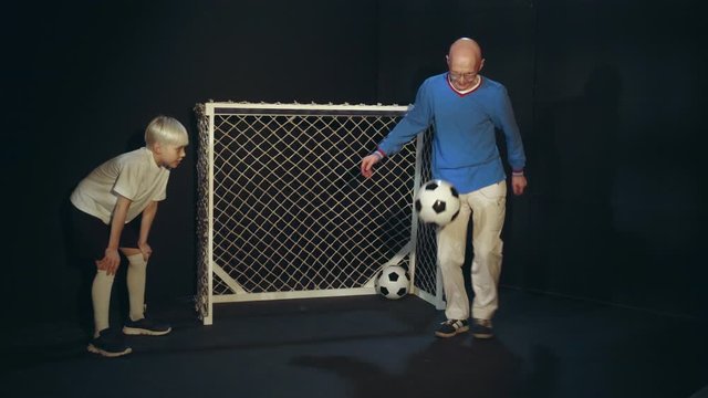 Old Man Is Showing His Soccer Skills To Young Footballer
