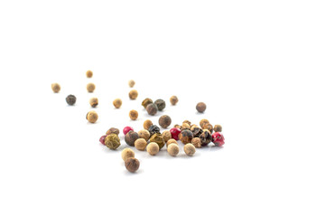 Red, green and black peppercorns or balls mixed isolated on a white background.
