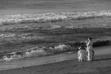Ketewel, Bali, Indonesia - March 13, 2010 : The Hindu priest and his assistants taking offers to...