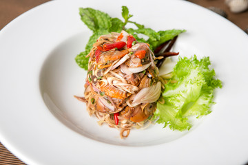thai herb spicy clams salad serve in white plate