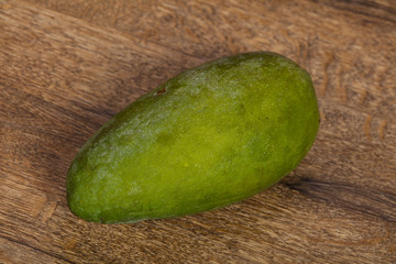 Green tasty mango over wooden background