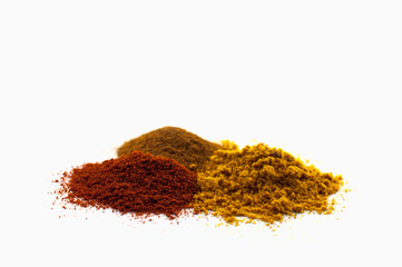 Mix of different powders like paprica and curry isolated on white background