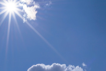 Naklejka na ściany i meble Blue sky with clouds and sun.