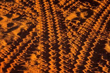 Australia – car tracks at a sandy outback gravel road at a desert after 4WD used the off-road...