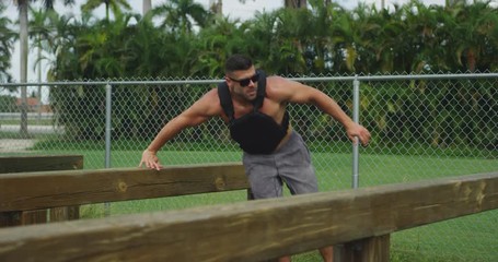 Athletic man performing obstacle course training