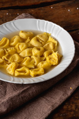 Cappelletti in brodo. Pasta italiana. Ravioli, tortellini