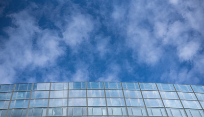 Fototapeta na wymiar Big business building on a background of blue sky with clouds