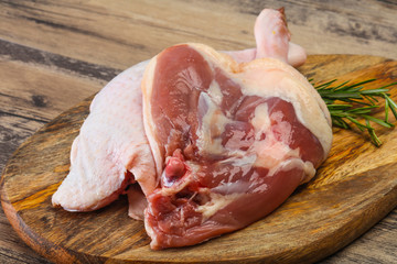 Raw duck leg served rosemary