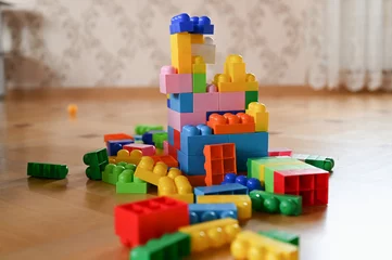 Fototapete Lego children's developing color constructor. scattered across the floor  © SYARGEENKA