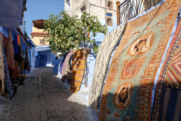 Carpet sale on streets of kasbah - old part of city Chefchaouen, Morocco.