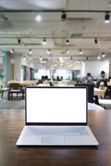 Laptop with white screen on wooden table