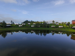 Fototapeta na wymiar Aerial sunrise lake, Beautiful Lake Patenggang with green tea field in ciwidey Indonesia 