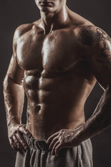 Studio portrait of a shirtless athletic tattooed male.