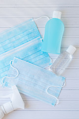 Blue and white medical mask, gel antiseptic for hand, antibacterial sanitizer. Protect against the coronavirus. Medical equipment.