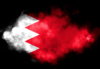 Kingdom of Bahrain flag performed from color smoke on the black background. Abstract symbol.